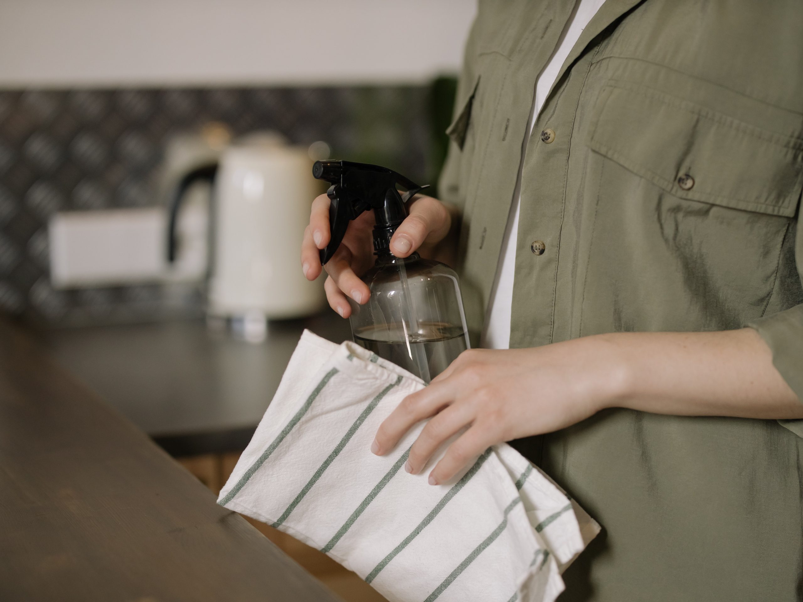 A woman holding cleaning materials for cleaning acrylic prints